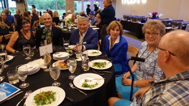 Ignite gala attendees sitting at a round table celebrating