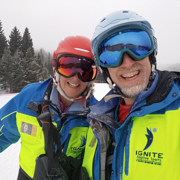 two Ignite Volunteer Instructors taking selfie on the slopes while it is snowing