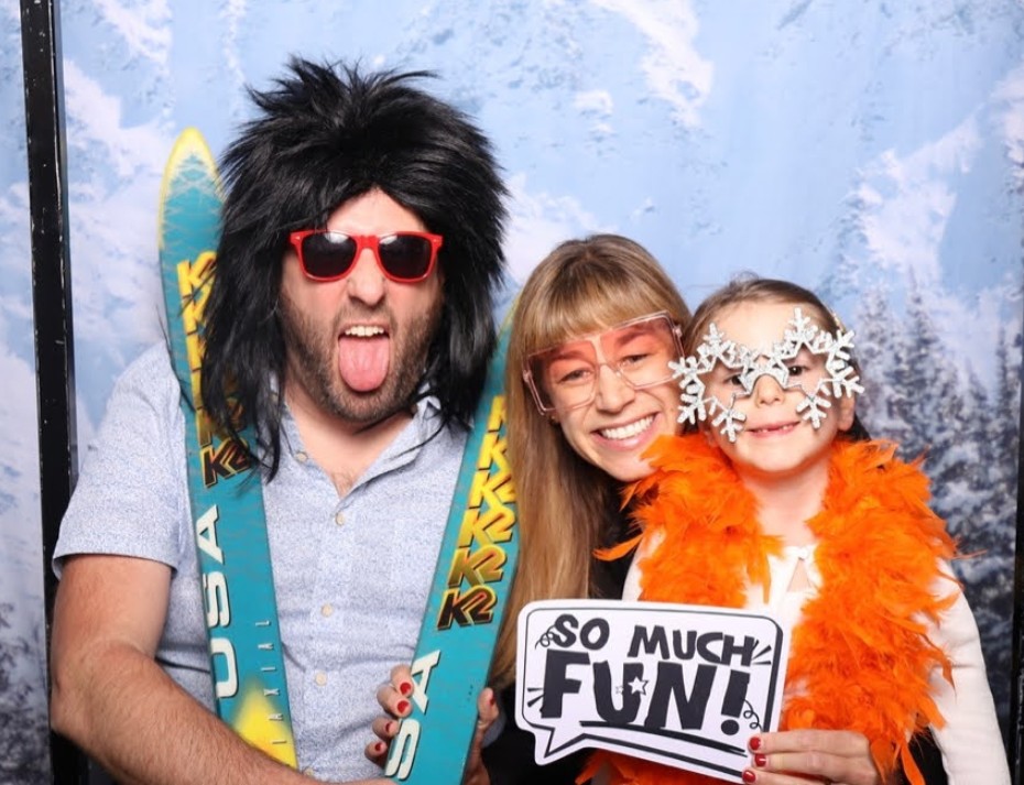 A family taking a photobooth picture at the annual Ignite gala